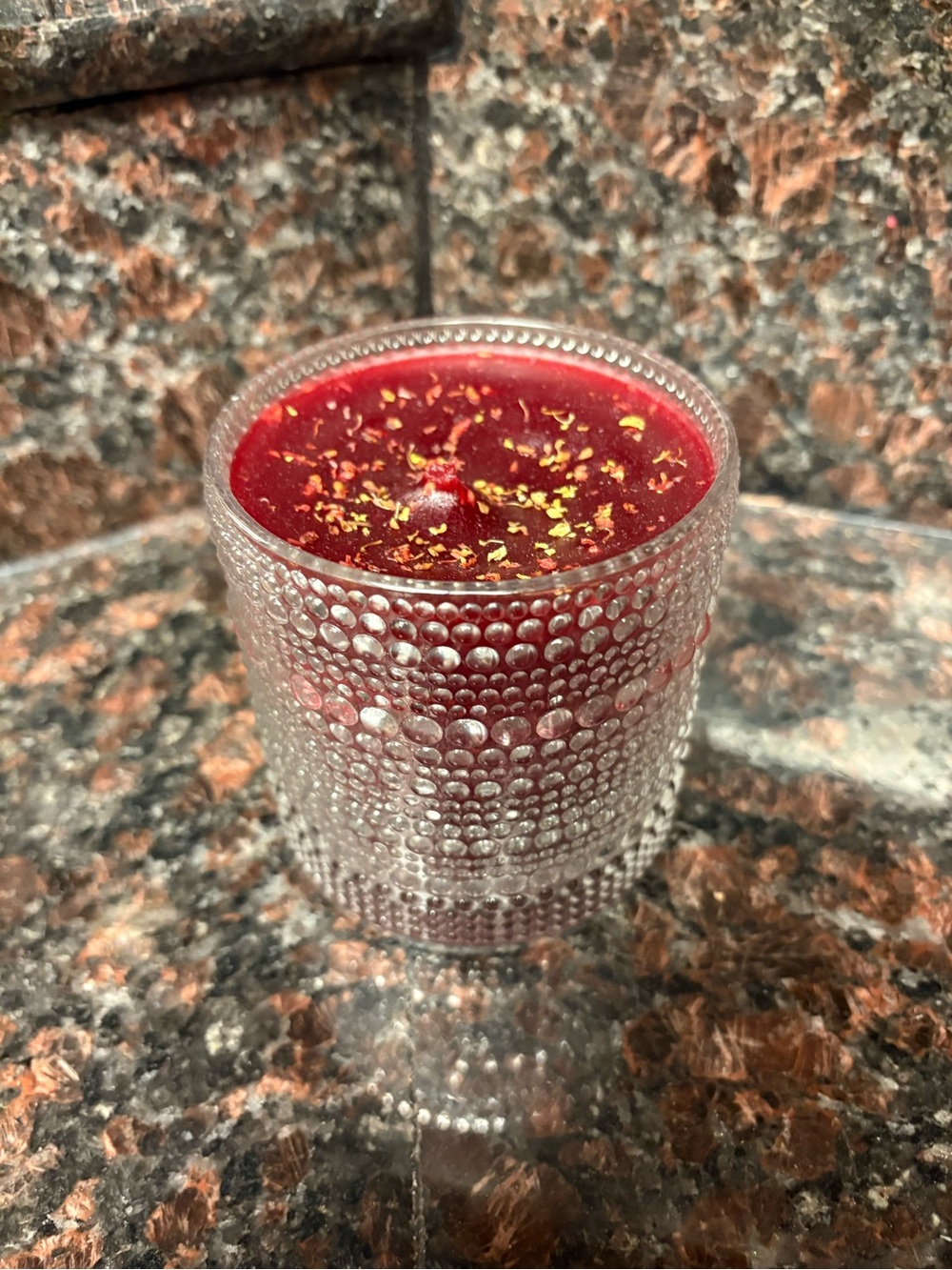 Handmade by me upcycled Red candle with yellow flower petals, scent is cherry